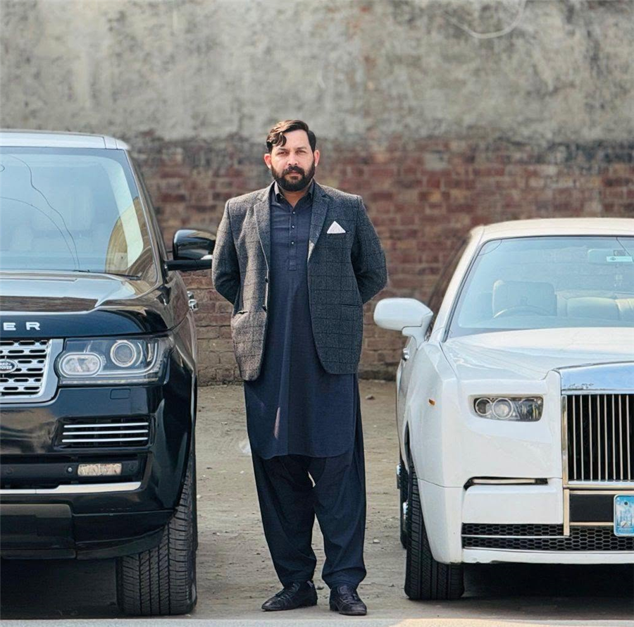 Raja Waqas, Founder and CEO of MyCar.inc, standing between two luxury vehicles
